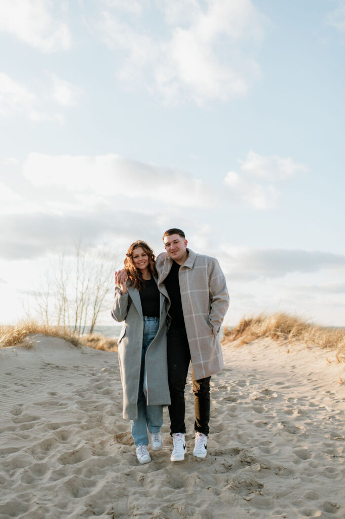 Couple posing for photos on a MI beach