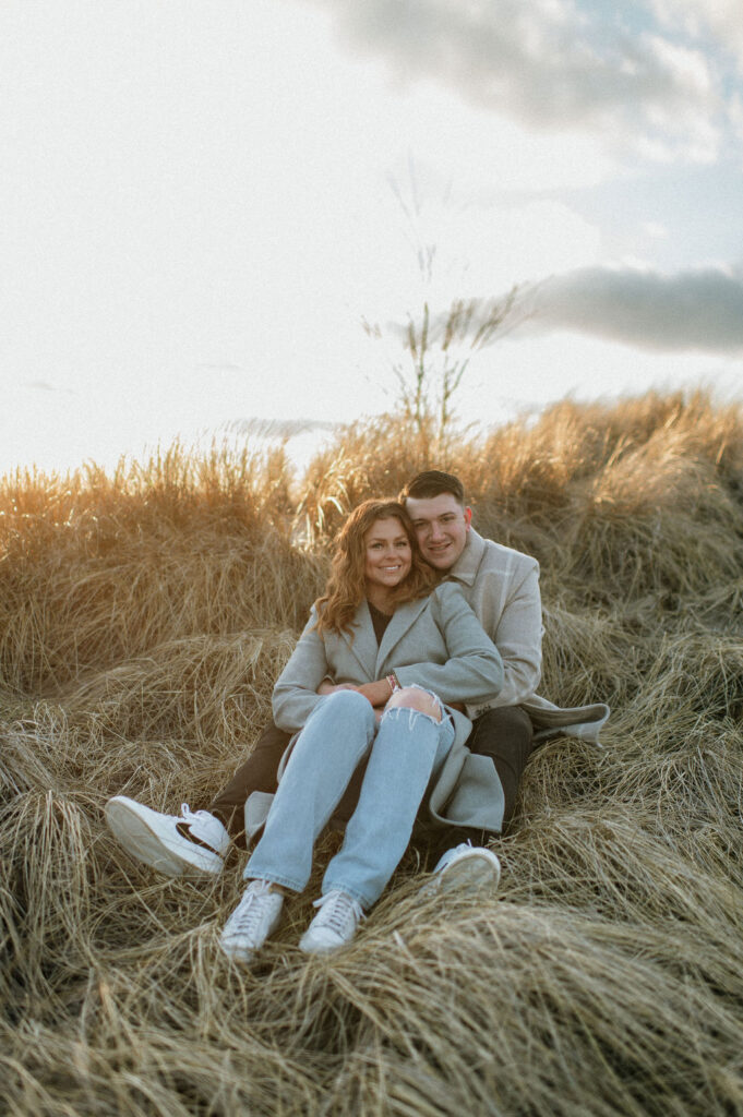 Couple posing for photos on a beach in MI