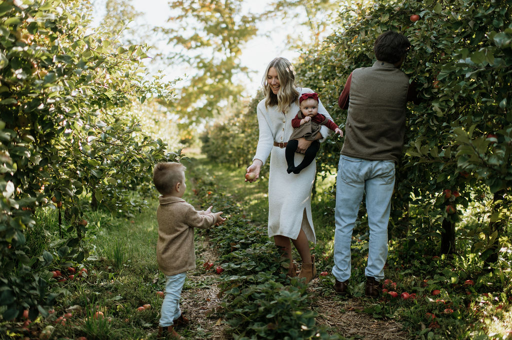Family picking apples for their outdoor family session