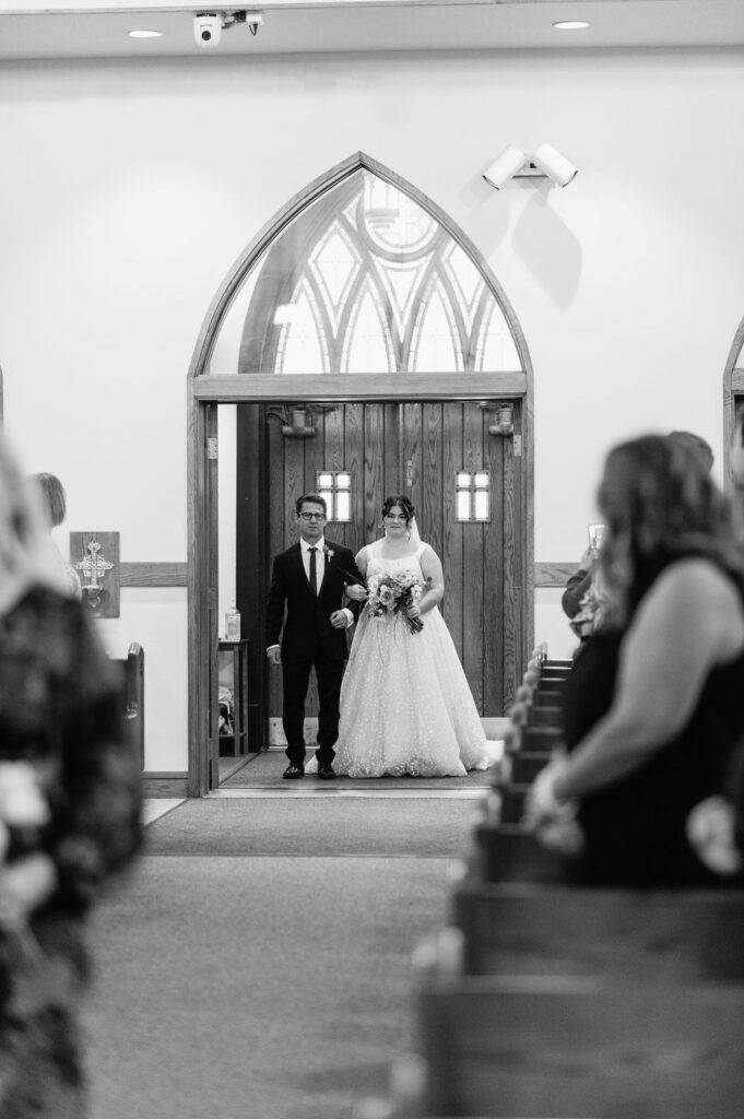 Fall indoor wedding ceremony at St. Bravo Catholic Church