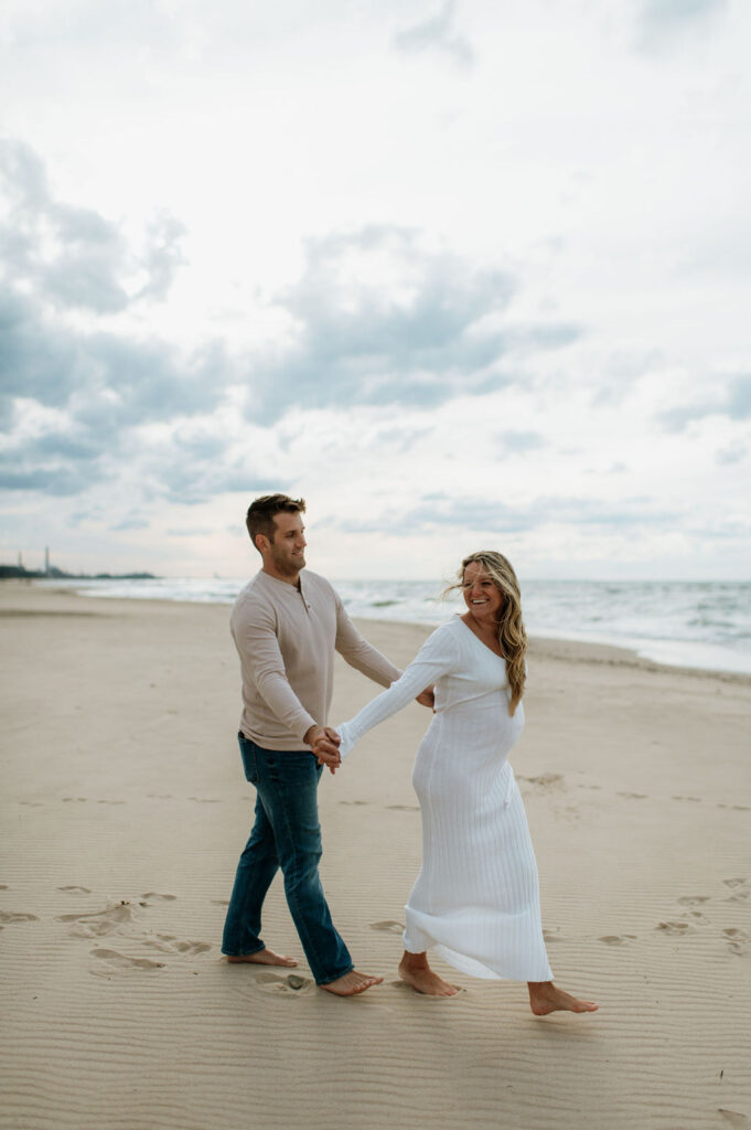 Man and woman on the beach at Indiana Dunes National Park for a family maternity photoshoot