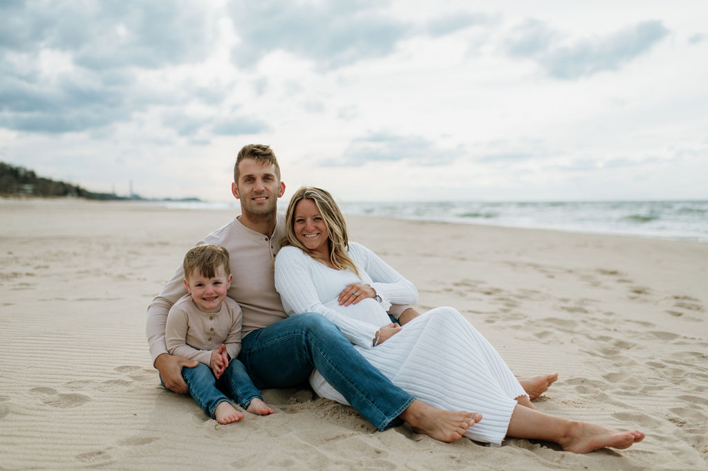 Family of three on the beach at Indiana Dunes National Park for a family maternity photoshoot
