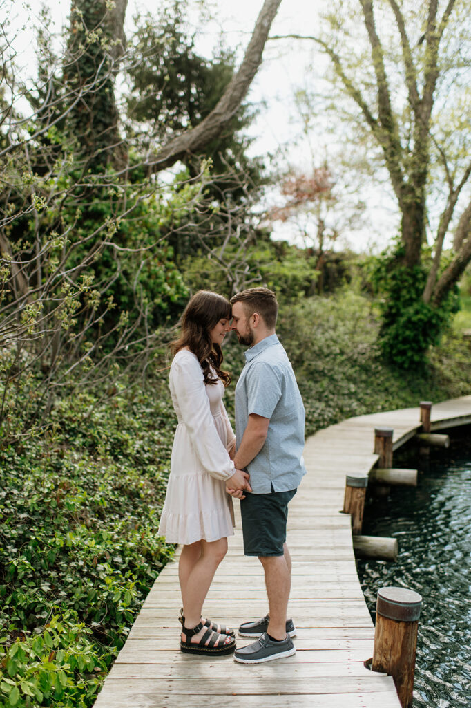 Couple posing for photos near a pond
