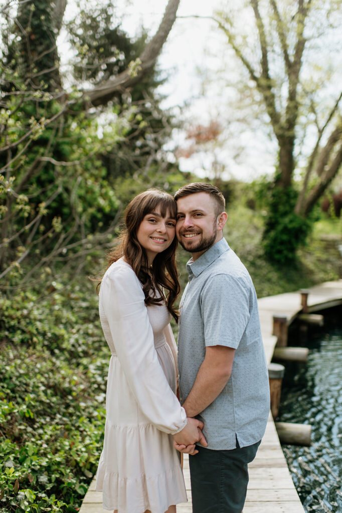 Couple posing for photo near a pond