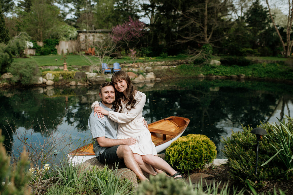 Couple sitting near a pond at Hamstra Gardens