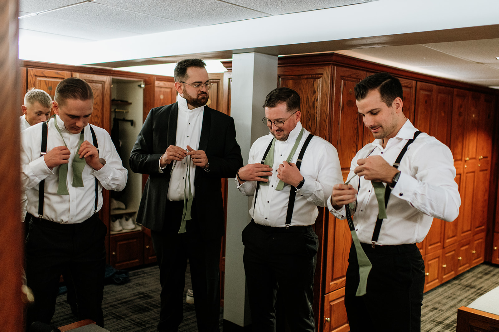 Groom and his groomsmen getting dressed for the wedding