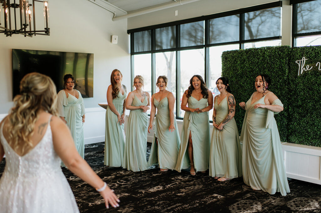 Bridesmaids turning around to see the bride for the first time