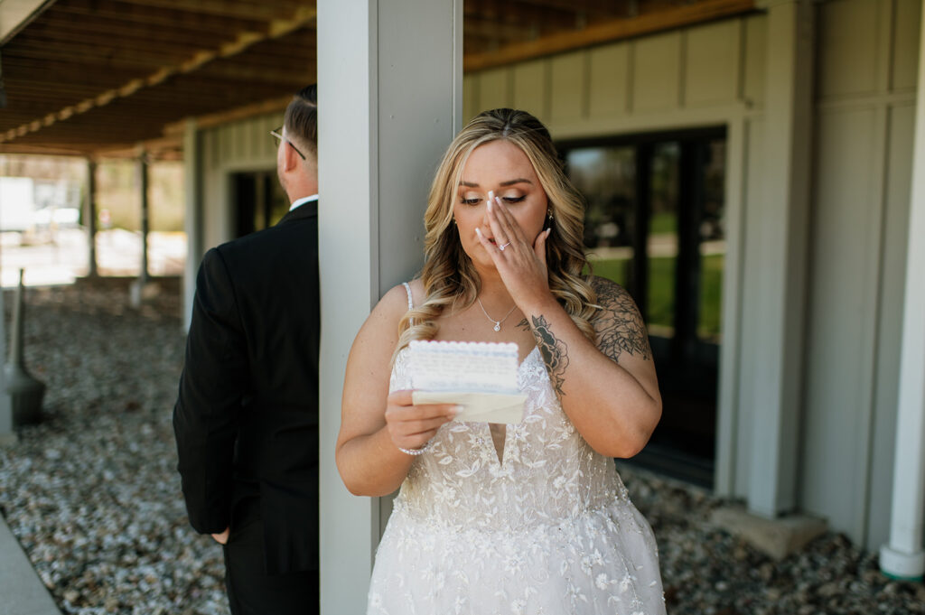 Bride wiping tears away as she reads her private vows to her soon to be husband from their Morris Park Country Club wedding in South Bend, Indiana