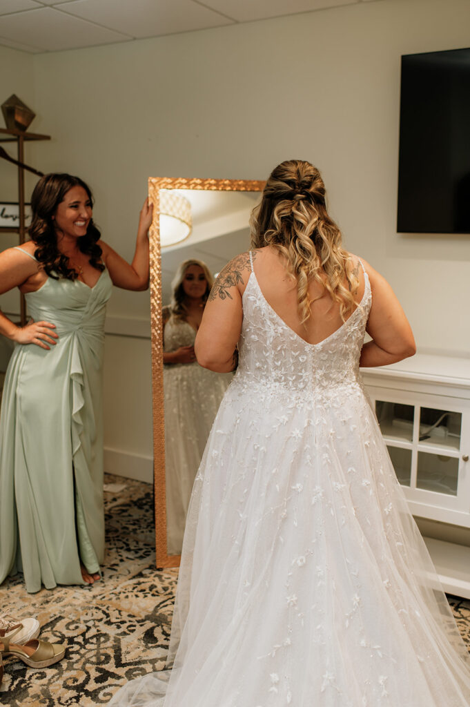 Bride looking at herself in the mirror