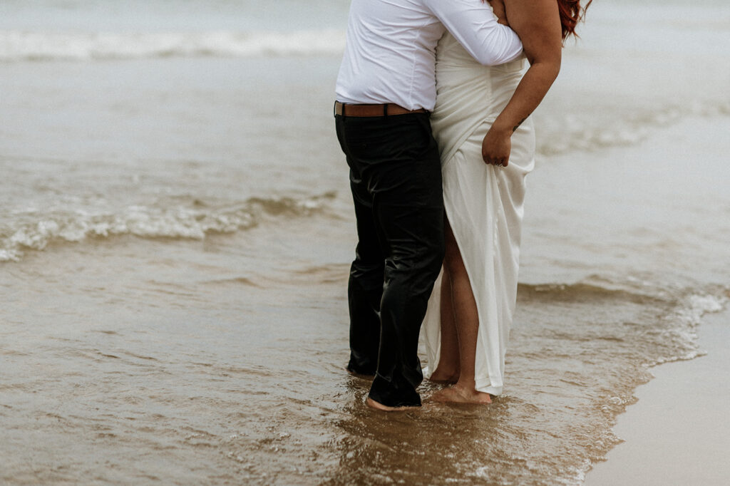 Bride and groom standing in Lake Michigan