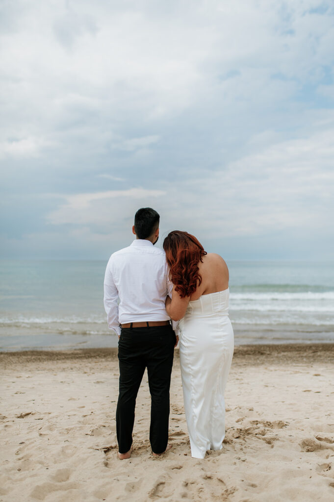 Bride and groom admiring Lake Michigan during their elopement in Indiana at Indiana Dunes National Park