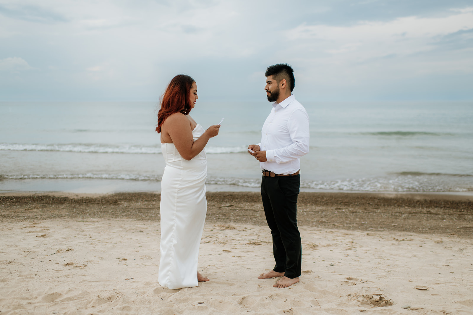 Bride reading her vows to her groom on the beach