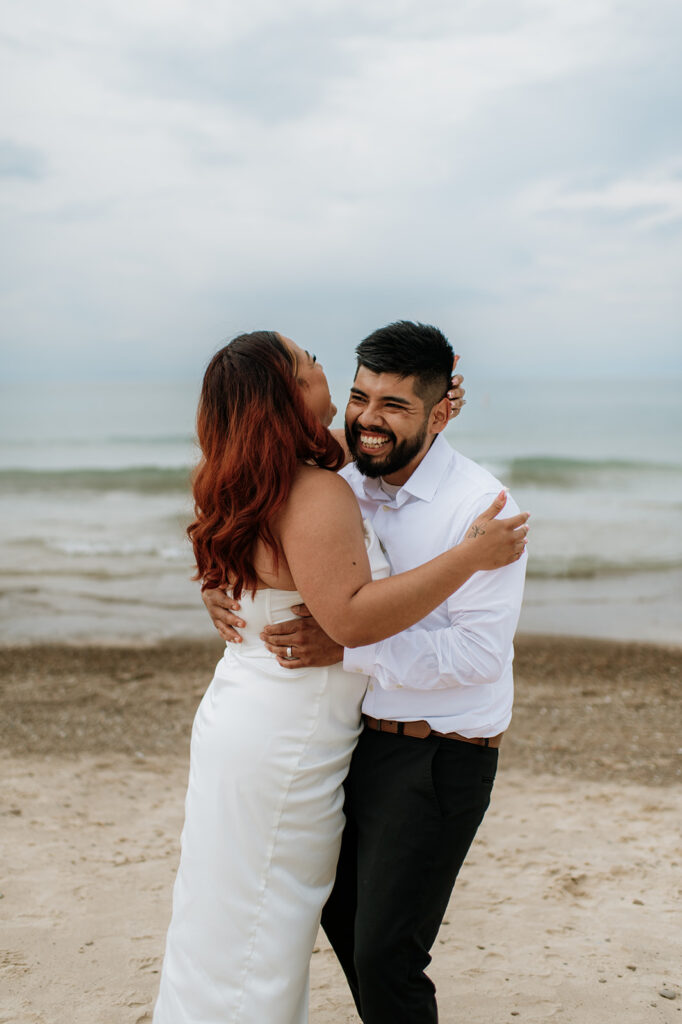 Bride and groom laughing together during their ceremony