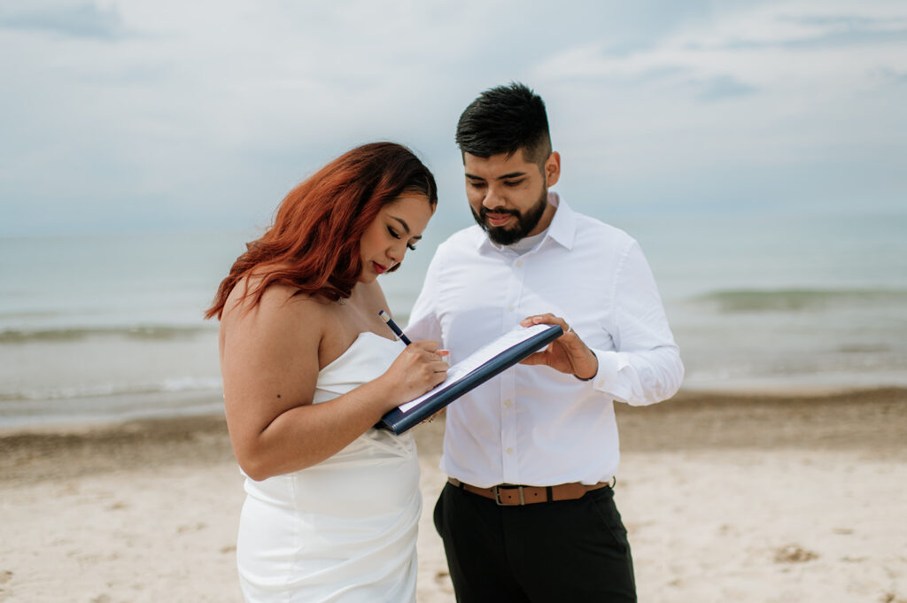 Bride and groom signing their marriage licence