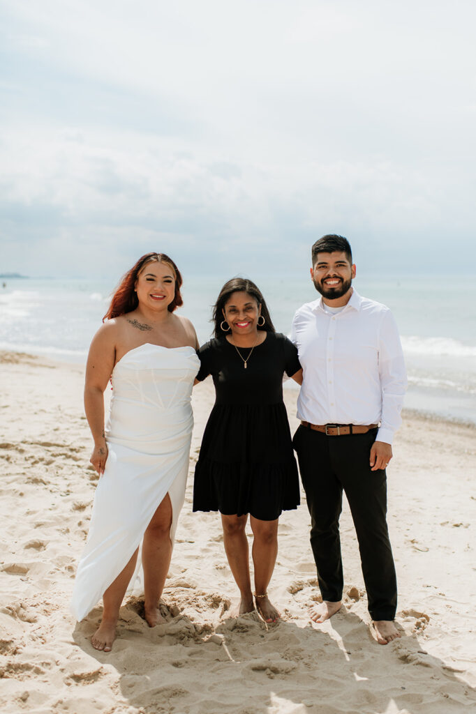 Bride and groom posing for photos with their officiant Kim from officiant-kim.com