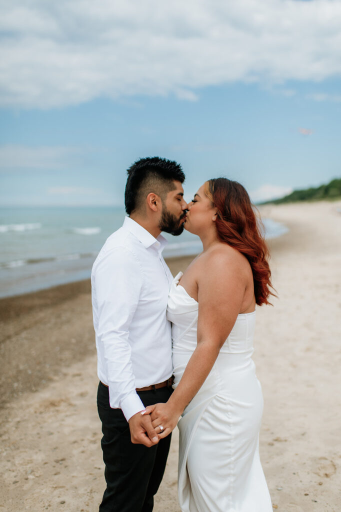 Bride and groom kissing on the beach during their elopement in Indiana