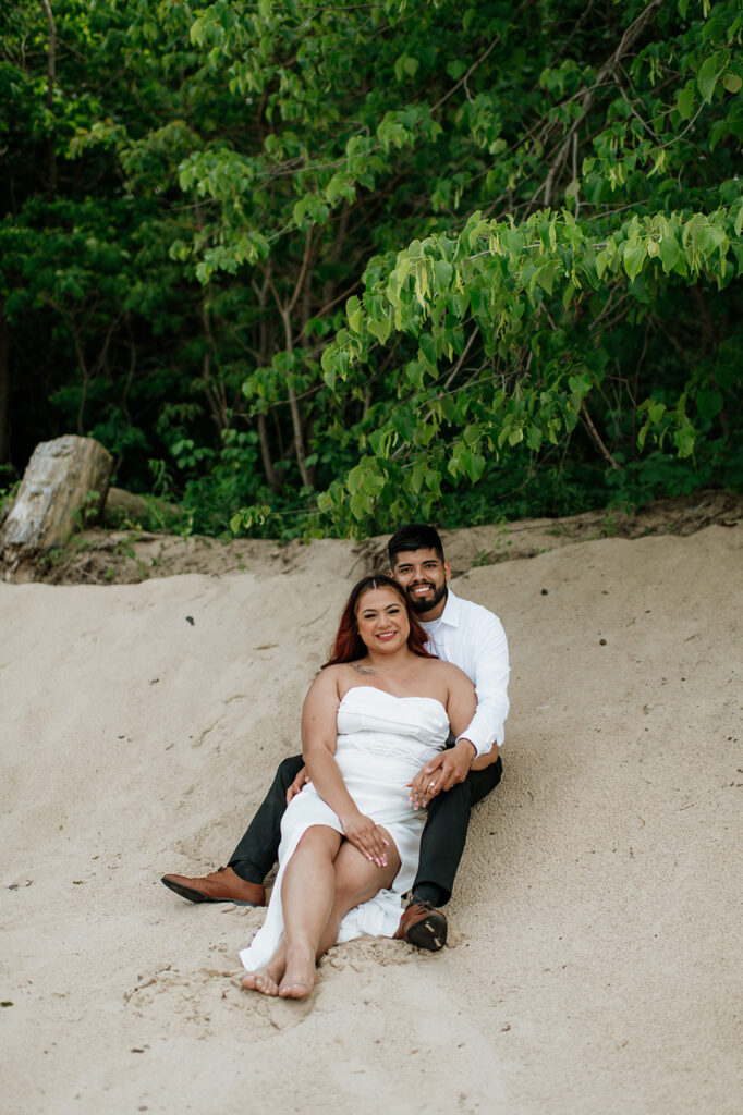 Bride and groom sitting on the beach of Indiana Dunes National Park