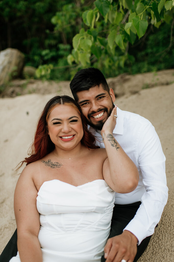 Bride and groom sitting on the beach of Indiana Dunes National Park