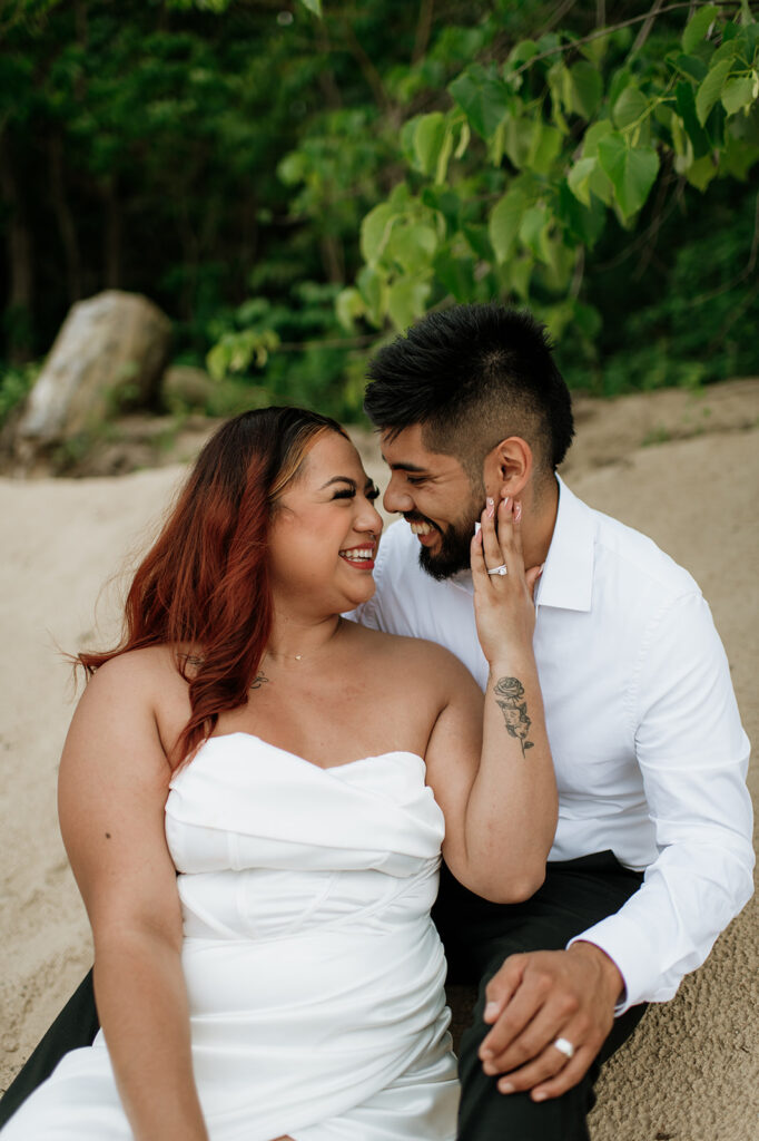 Bride and groom sitting on the beach of Indiana Dunes National Park