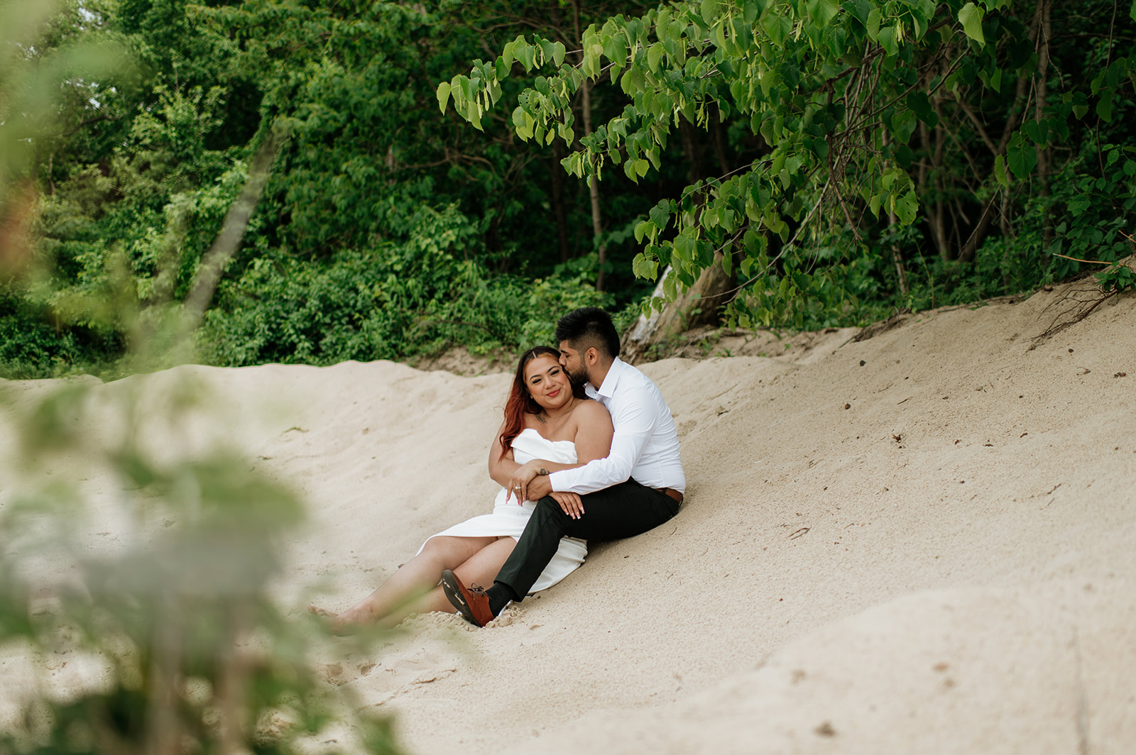 Bride and groom sitting on the beach of Indiana Dunes National Park