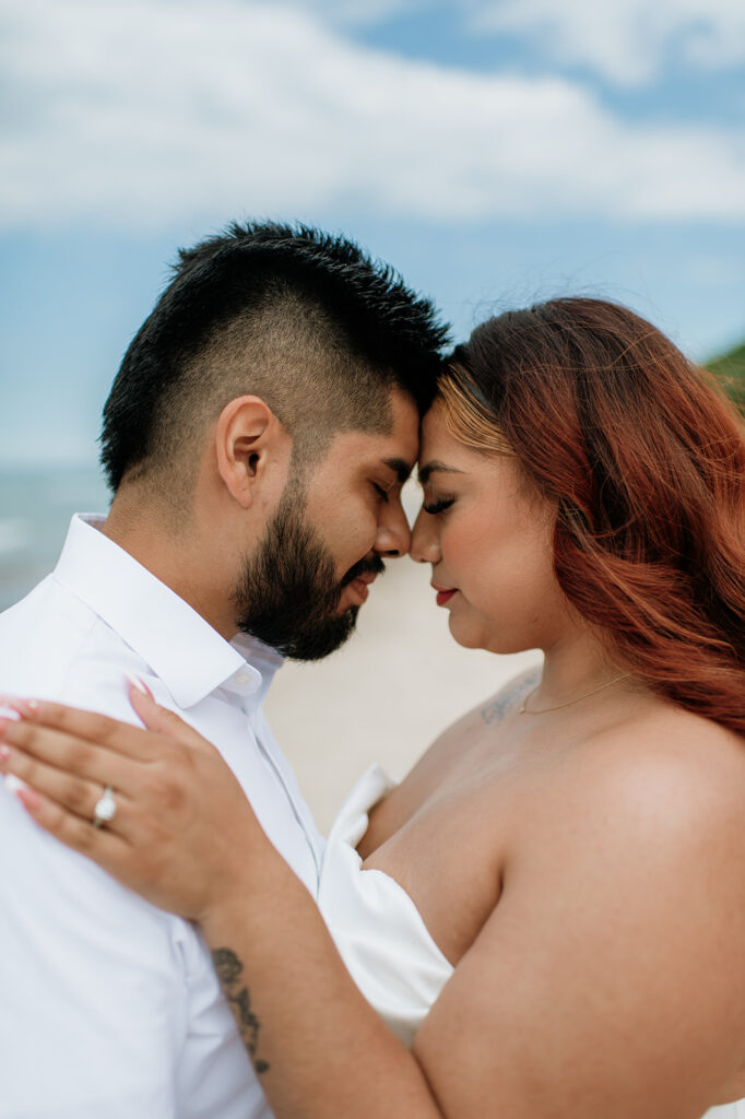 Close up photo of a bride and groom with their foreheads touching for their beach elopement in Indiana