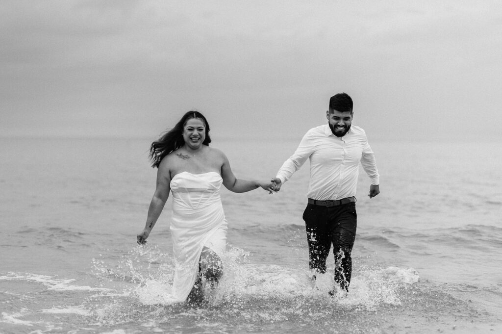 Bride and groom running through Lake Michigan during their elopement in Indiana