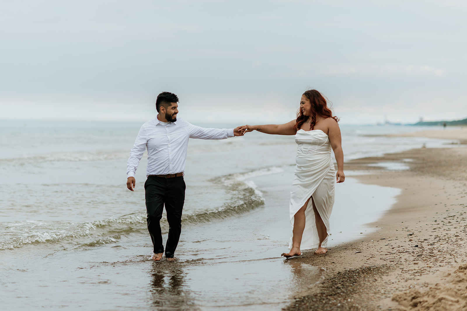 Bride and groom walking the shoreline of Lake Michigan for their elopement in Indiana