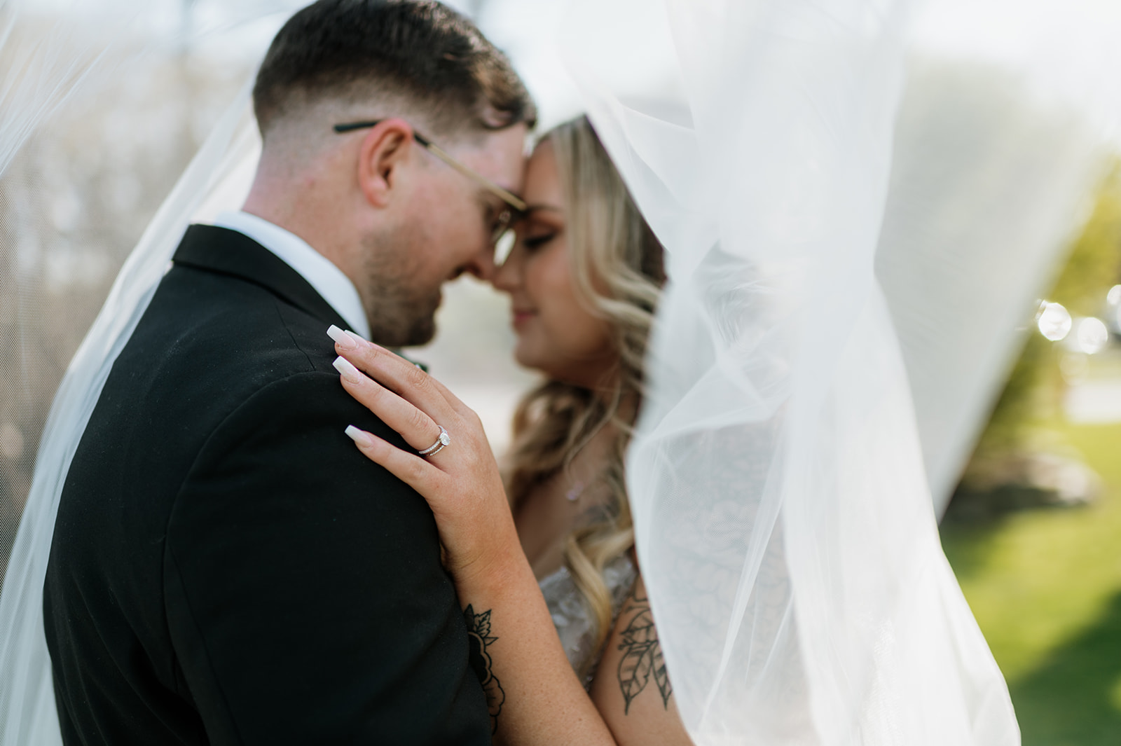 Close up shot of a bride and groom under the brides wedding veil