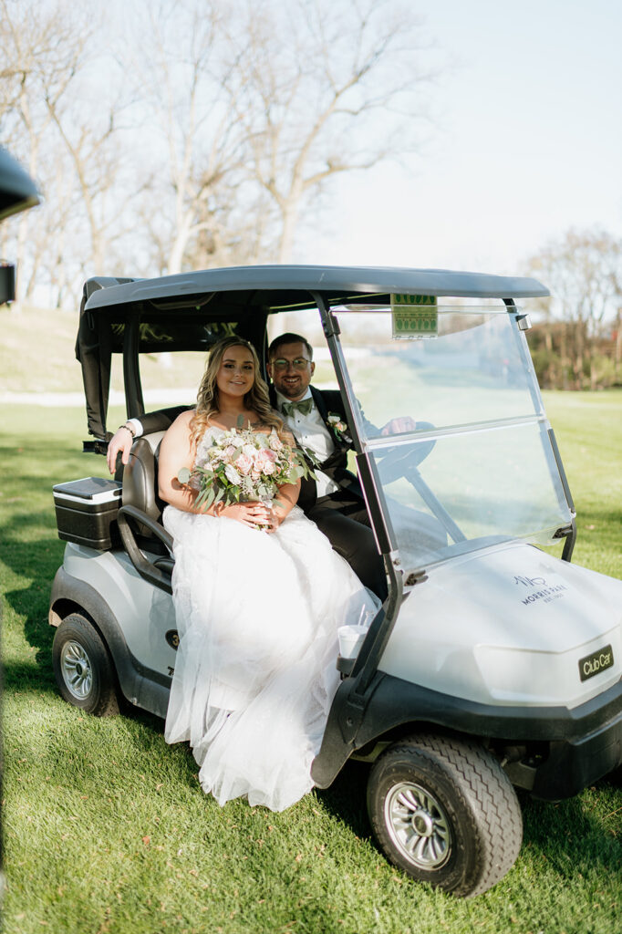 Bride and grooms riding in a golf cart during their Morris Park County Club wedding in South Bend, Indiana