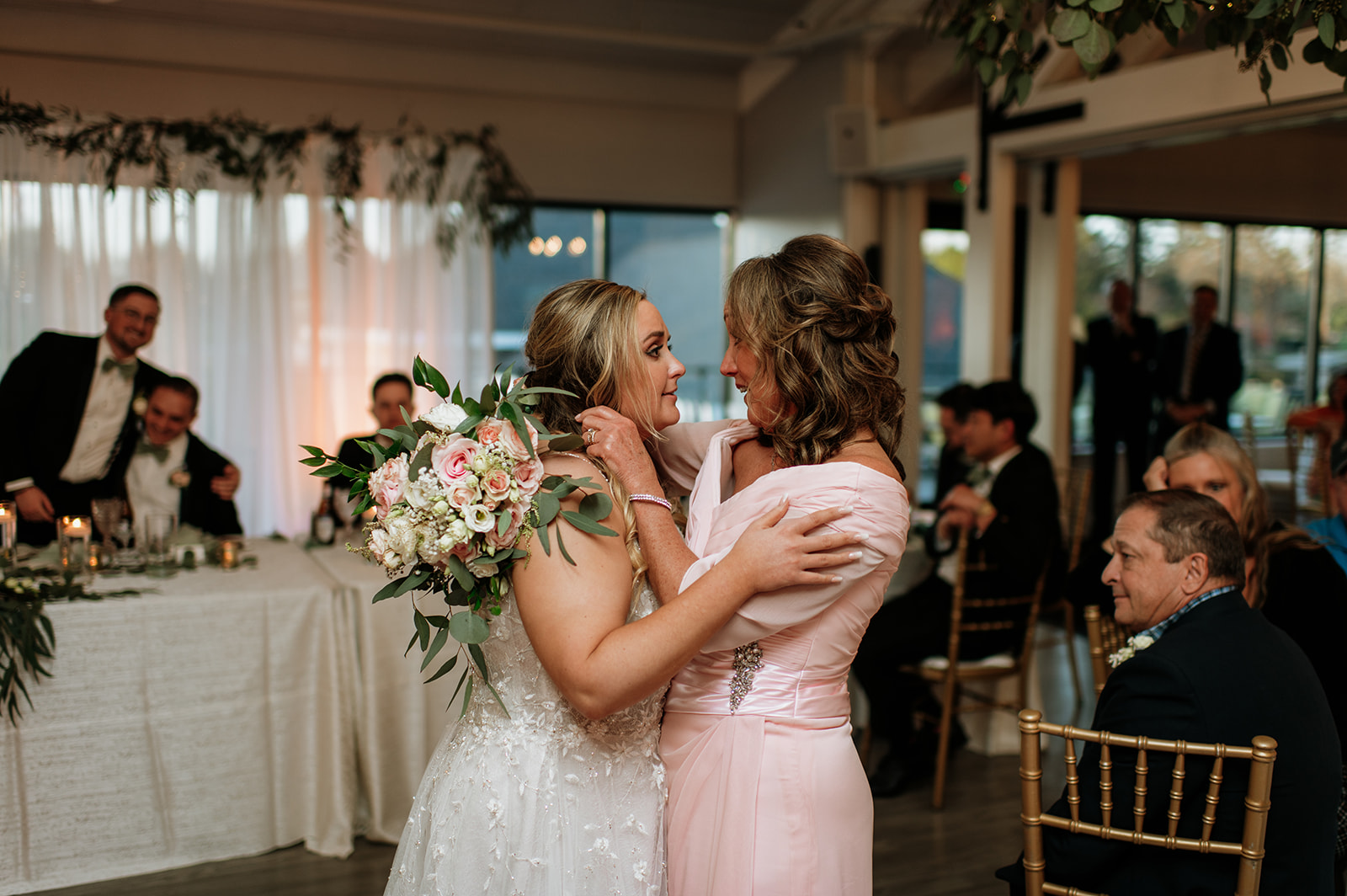 Bride hugging mother of the groom during the reception