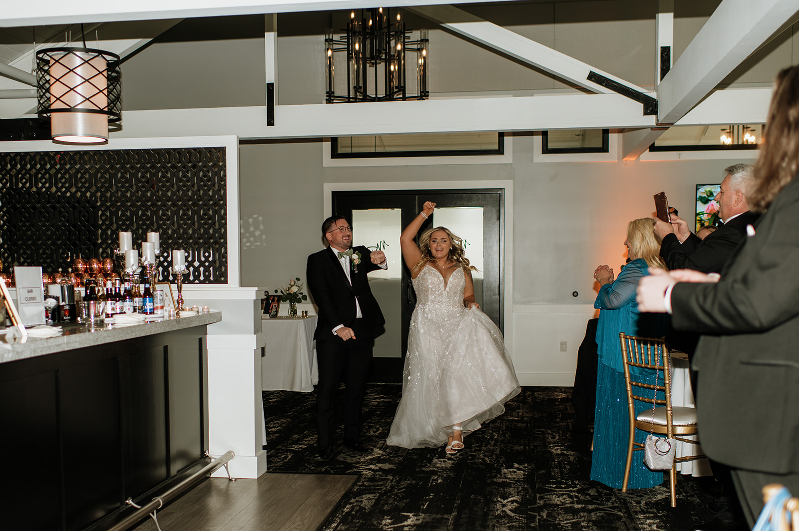 Bride and groom entering their wedding reception