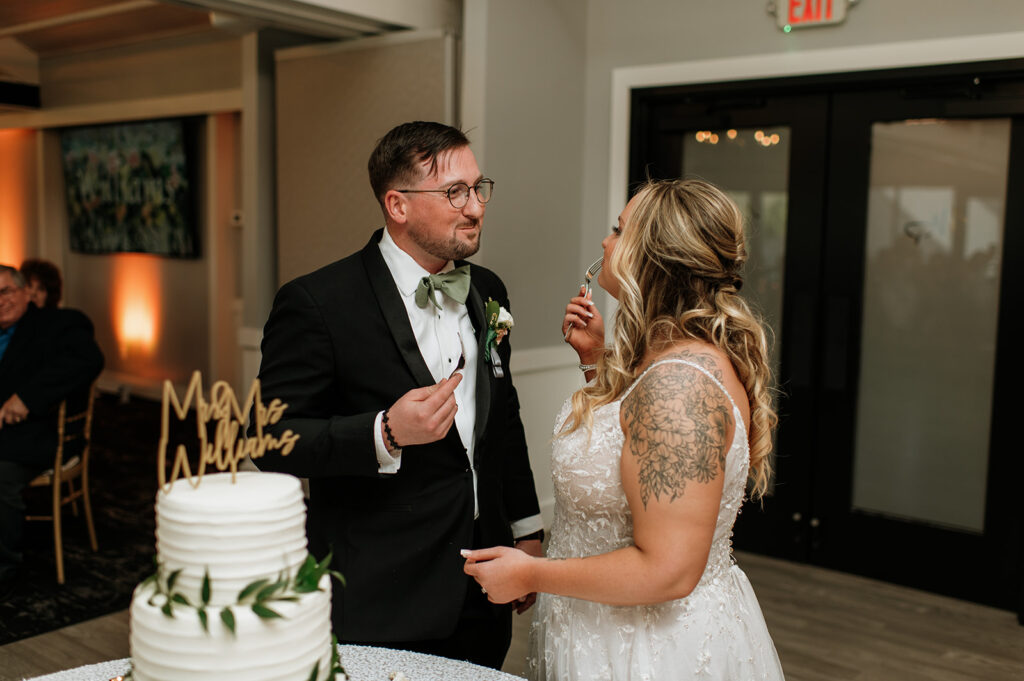 Bride and groom cutting their wedding cake