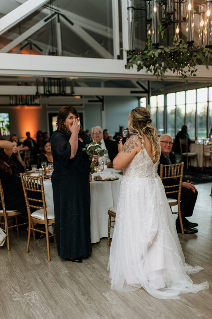 Bride giving her bouquet to her mother during the reception