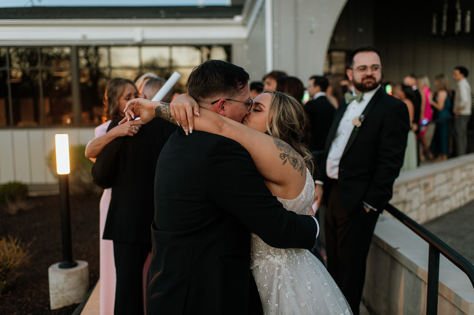 Bride and groom kissing during their wedding exit