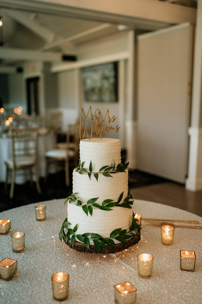 Three tiered wedding cake with greenery