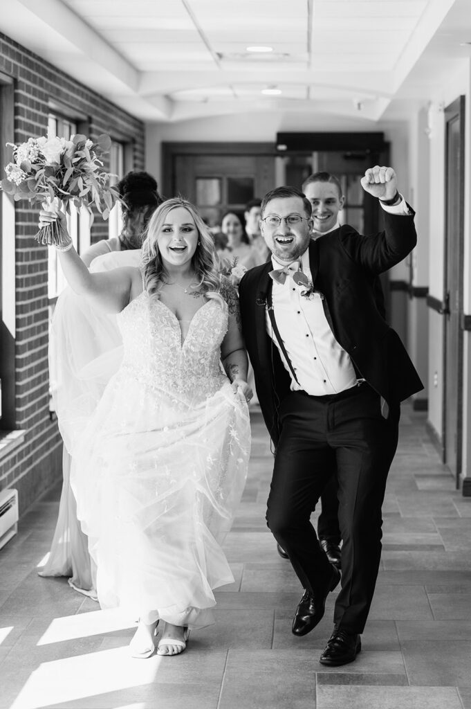 Black and white photo of a bride and groom after their St. Pius X Catholic Church wedding ceremony