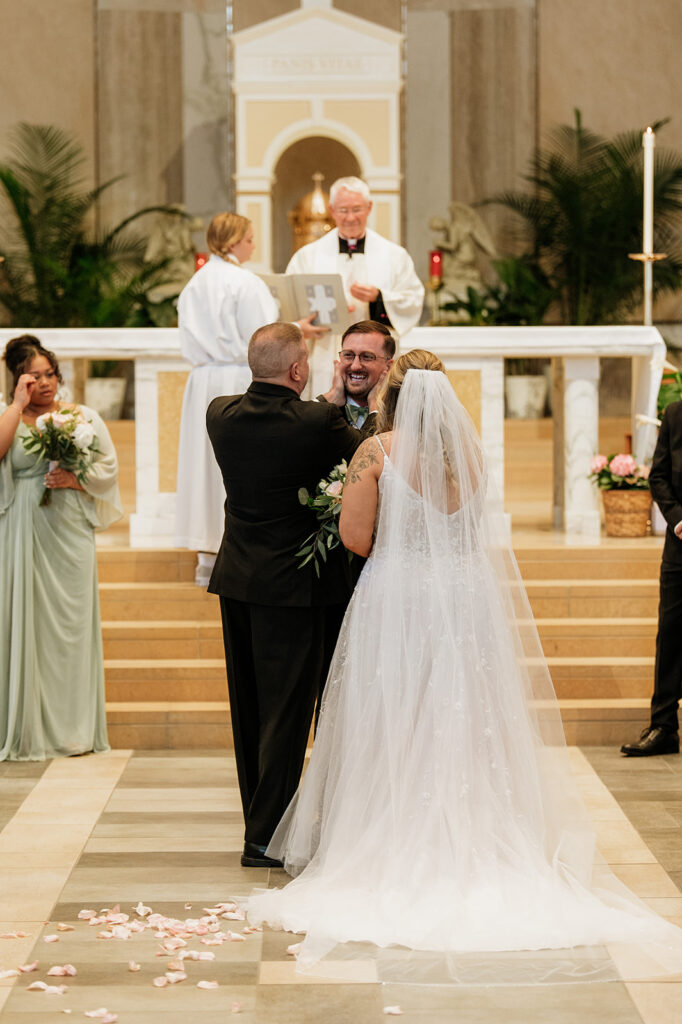 Brides father giving her away at the alter 