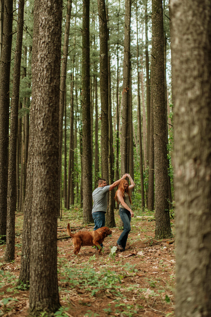 Couple in the woods with their dog