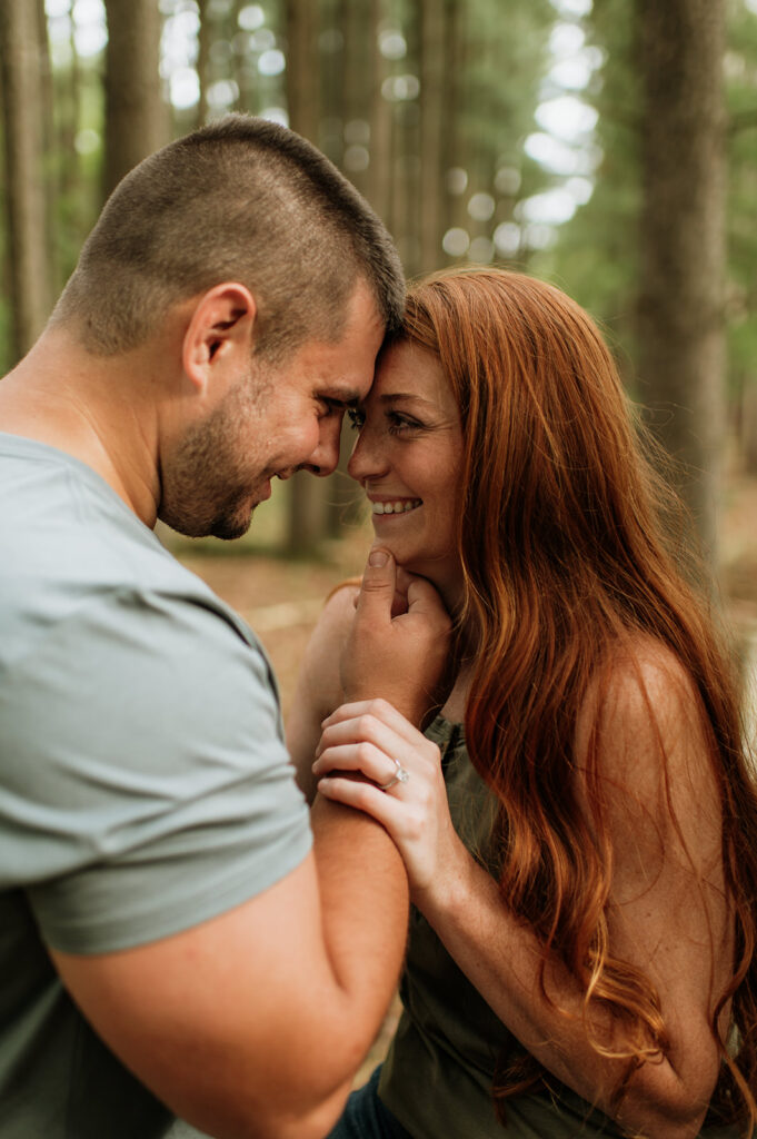 Man holding his fiancés face for their engagement photos in Indiana