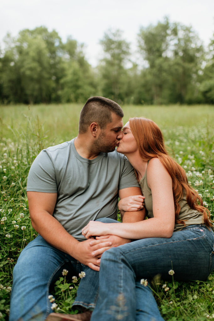 Couple kissing in a field of wild flowers