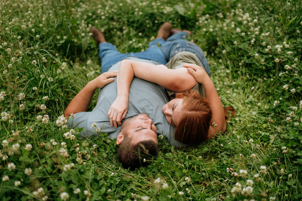 Couple laying in a field of wild flowers