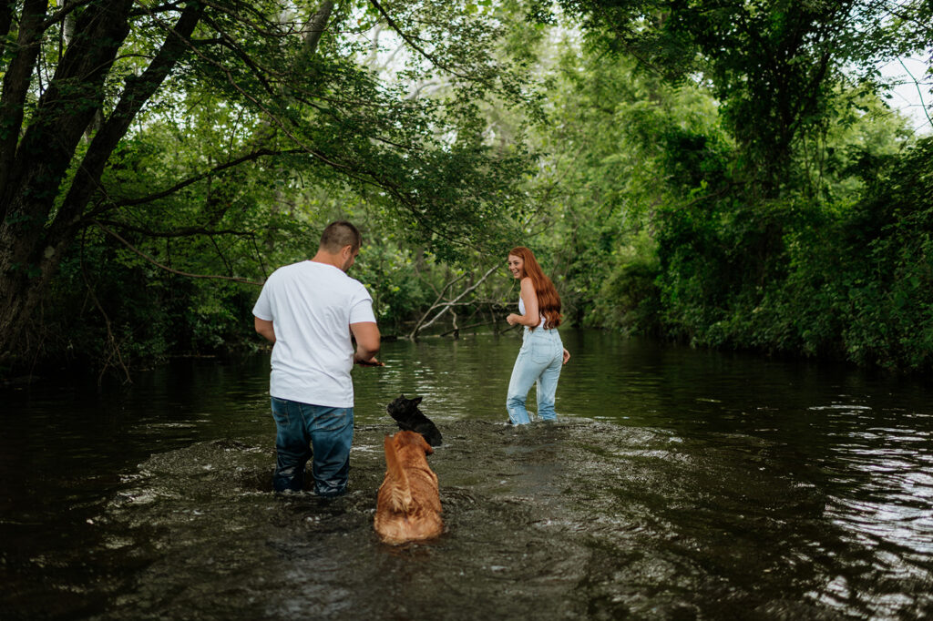 Couple and their two dogs playing in an Indiana creek