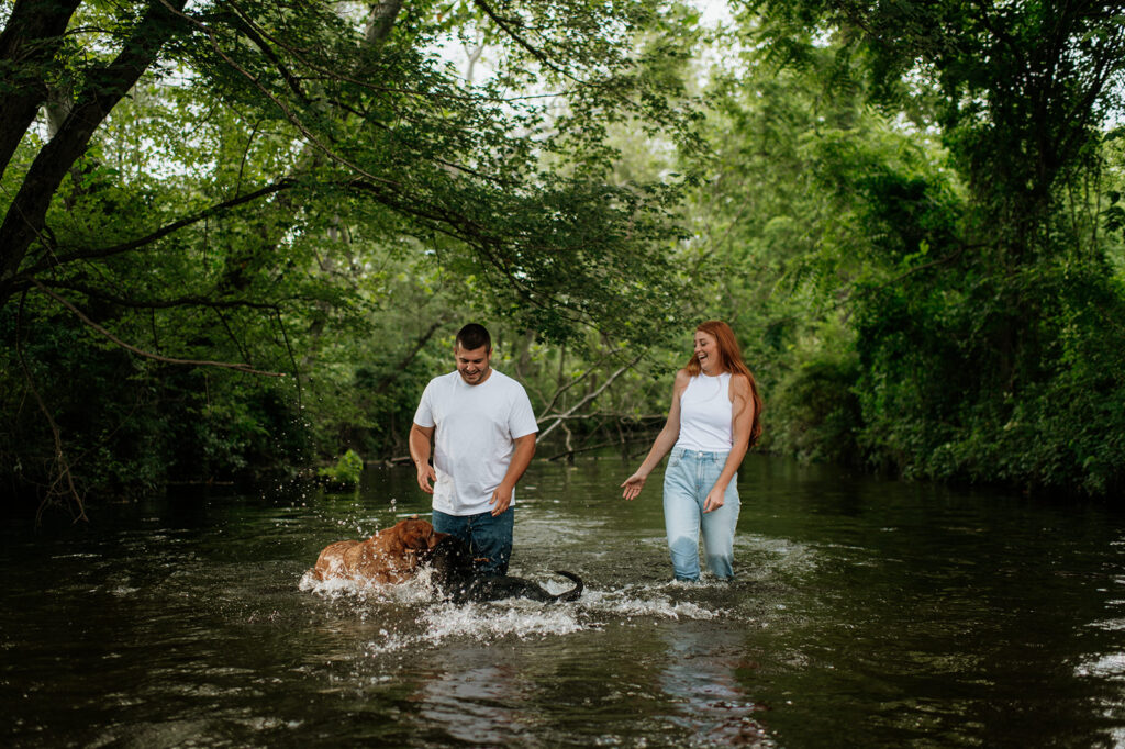 Couple and their two dogs playing in an Indiana creek