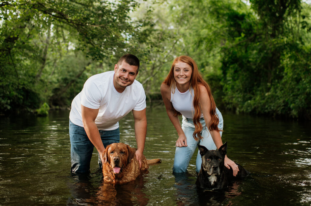 Couple and their two dogs playing in an Indiana creek