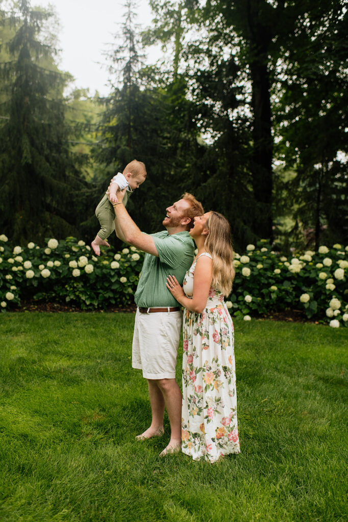 Mother and father being playful with their young son during their family photo session