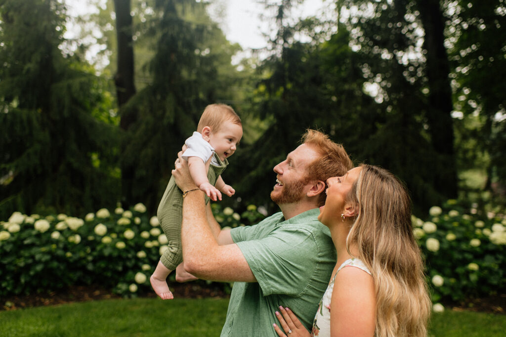 Mother and father being playful with their baby son during their family photoshoot