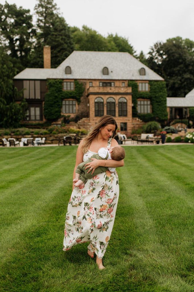 A mother holding her baby while he naps during their family session