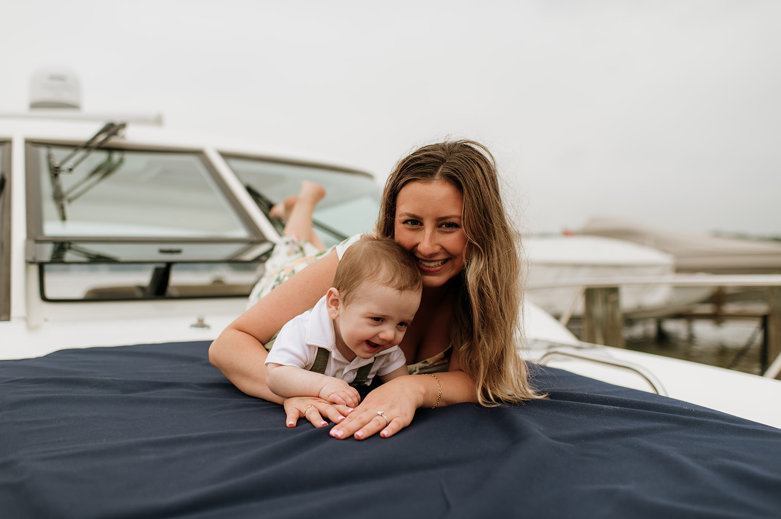 A mother laying with her baby on a big during their Lake Michigan family photos in Holland