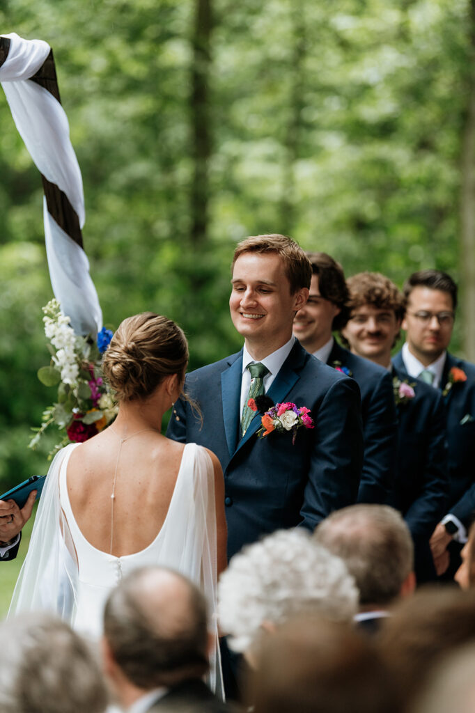 A rainy and colorful outdoor wedding ceremony on the Covered Patio at The Wooded Knot in Tippecanoe, Indiana