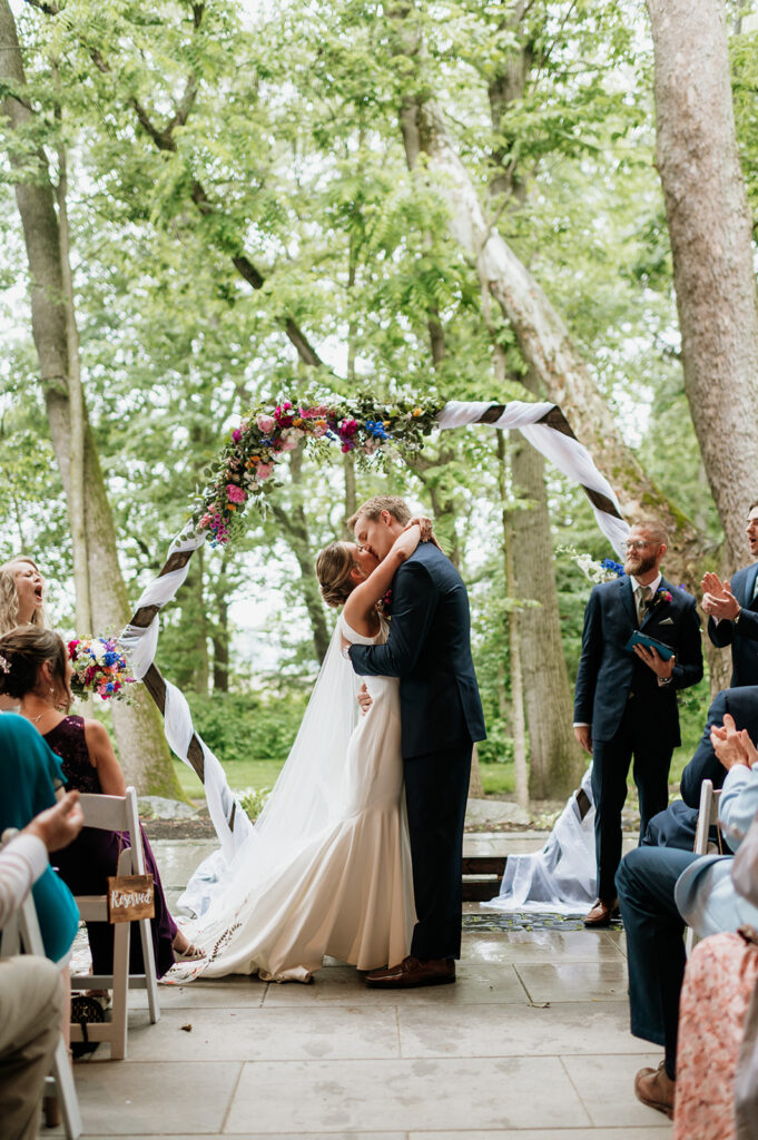 Bride and groom kissing during their ceremony